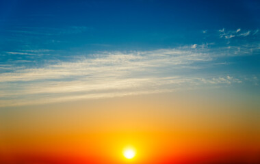 Stunning sunset with orange and blue clouds in dramatic sky