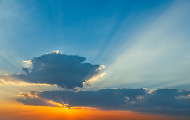 Stunning sunset with orange and blue clouds in dramatic sky