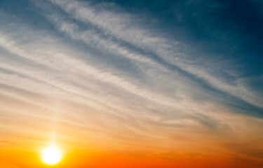 Stunning sunset with orange and blue clouds in dramatic sky