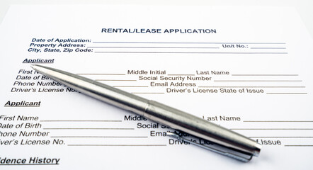 Rental and lease application letter with pen.
