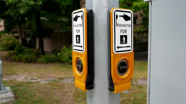 Woman pressing a button for crossing the street with 4k resolution.