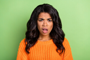 Fototapeta premium Photo of shocked impressed dark skin woman wear orange sweater open mouth isolated green color background