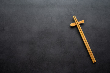 A pair of chopsticks on a black background