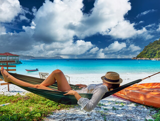 Woman in hammock on beach