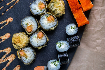 Different types of sushi and rolls in restaurant