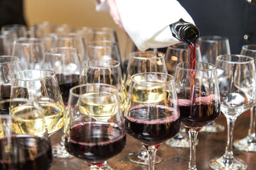 Red vine pouring into glasses