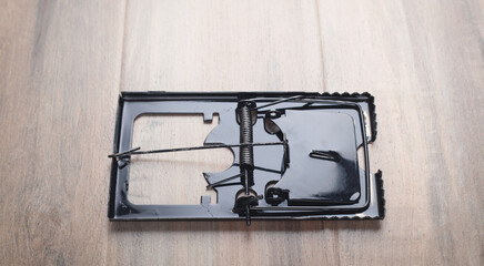 Mouse trap on the wooden table.