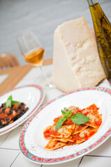 Cooked ravioli in restaurant and parmesan cheese