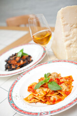 Cooked ravioli in restaurant and parmesan cheese