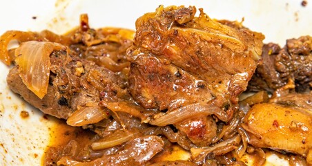 fried meat fried onions close-up in a plate