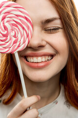 surprised woman with open mouth lollipop in hand emotions enjoy dessert