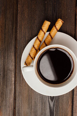 cup of coffee on a wooden table sweets breakfast top view