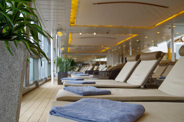Luxury sun loungers and deck lounge chairs on terrace, patio or balcony sun deck of luxury yacht...