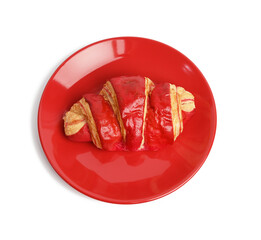 baked croissants with cherry glaze on a red ceramic plate