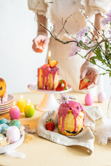Easter table setting. Easter cake craffin. Woman on background