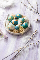 Obraz na płótnie Canvas Blue Easter eggs on purple wooden table background