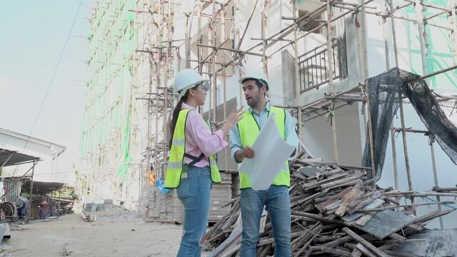 Team of caucasian man contractor, woman engineering, partner inspect defect of building, apartment or home, handshake with colleague after finish work. Engineer, architect or builder worker concept.