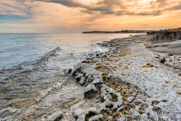 Seascape of Cyprus stone coast at sunset