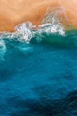 Fotobehang Beautiful sandy beach with blue sea, vertical view. Drone view of tropical blue ocean beach Nusa penida Bali Indonesia. Lonely sandy beach with beautiful waves. Beaches of Indonesia. Copy space © MISHA