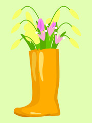 Yellow rubber boots with a bouquet of spring flowers