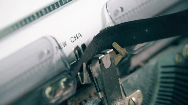 close-up view of typing words NEW CHAPTER on vintage typewriter