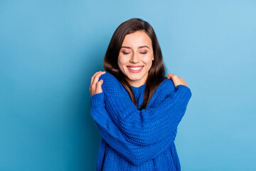 Photo of young lovely dreamy good mood positive smiling girl hug herself wear knitted jumper...