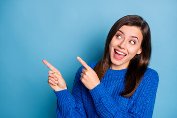 Photo of young beautiful happy positive good mood girl smiling look point finger in copyspace isolated on blue color background