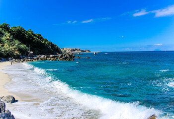 beautiful beach in mediterranean sea in calabria with blue sky and waves