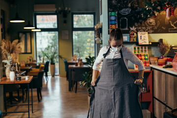 waitress preparing for work in cafe