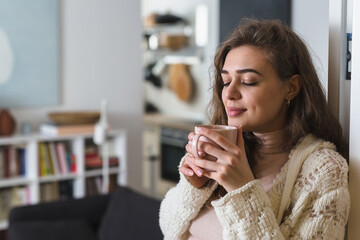 portrait of woman in her apartment. she drinking coffee