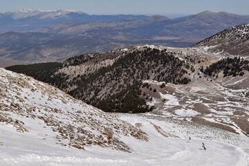 Ski trail in a ski resort and skier