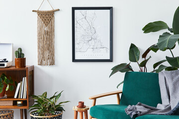 Stylish interior of living room with design wooden shelf, velvet sofa, a lot of plants, mock up poster map, vinyl recorder, book, macrame and personal accessories in vintage home decor. Template.