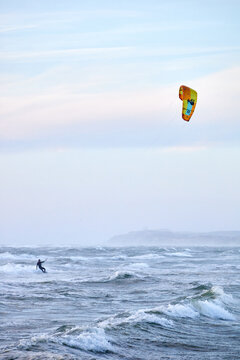 kite surfing on the water with yellow kite
