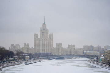 View on the Moskvoretskaya embankment and high-rise building on the Kotelnicheskaya embankment and Moskva-river. Winter cityscape. Moscow, Russia