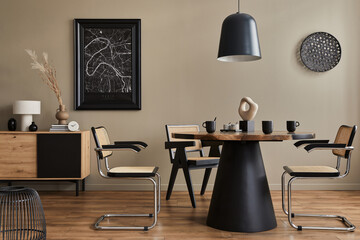 Modern composition of dining room interior with design wooden table, stylish chairs, decoration, teapot, cups, vessel, commode, black mock up poster map and elegant accessories in home decor. Template