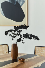 Stylish composition on the design table with elegan black eucalyptus flowers in timber vase and...
