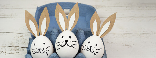 Easter background banner panorama greeting card -Close-up from white painted eggs and easter bunny...