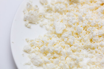 Milk curd on a white plate as a background.