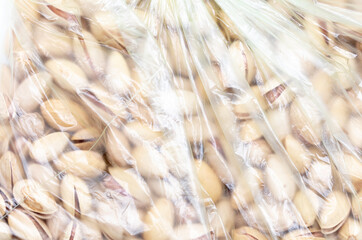 Pistachios in a plastic bag as a background.