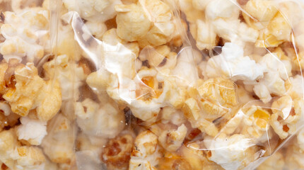 Popcorn in a plastic bag as a background.