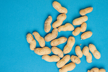 peanuts in shell blue background close-up top view
