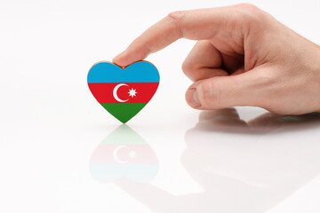 Flag of Azerbaijan. Love and respect Azerbaijan. A man's hand holds a heart in the shape of the...