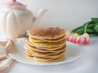 A stack of pancakes with honey