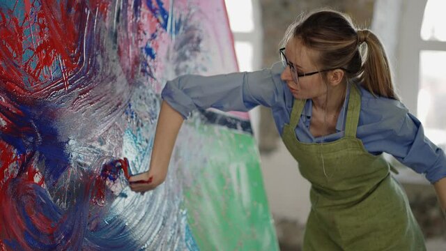 Contemporary painter creating abstract modern art using hands
