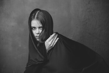 black and white photograph of a young woman with a cloth on her head and a cropped view close-up