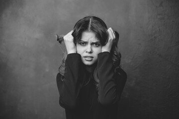 young woman gesturing with her hands on a gray background black and white photography portrait...