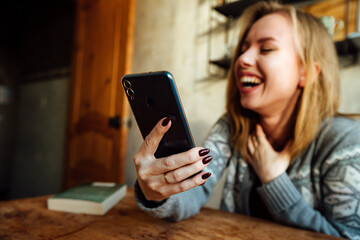 the girl laughs while talking on the phone