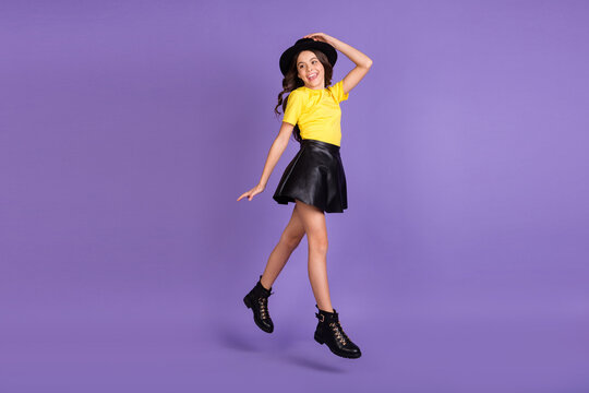 Full size profile photo of nice optimistic brunette hairdo girl jump wear cap t-shirt skirt shoes isolated on lilac background