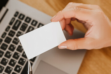 Man holding a business card with blank background in office