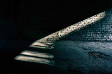 streak of light on a brick wall in a tunnel.
